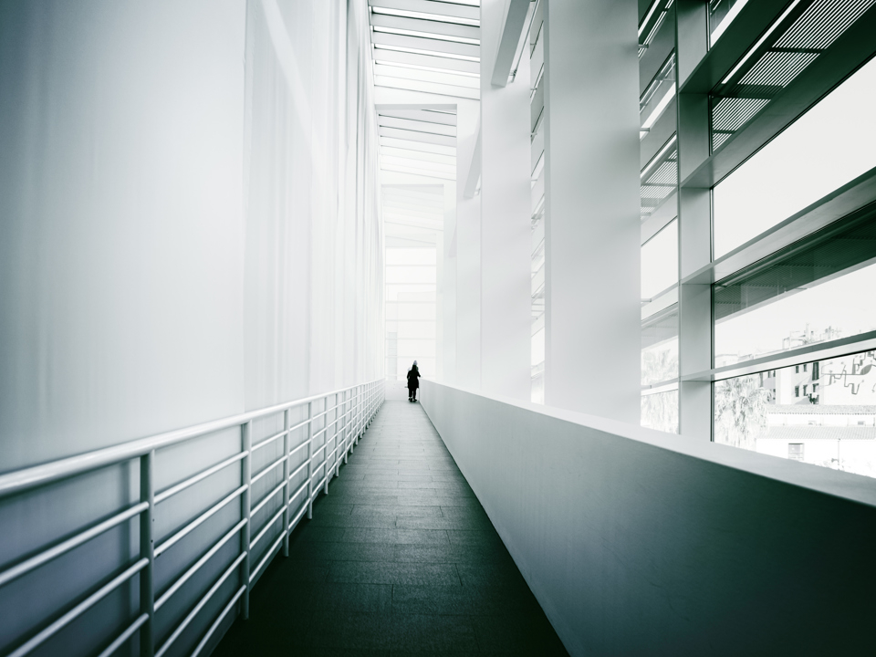 A corridor inside a building with aluminium components. 