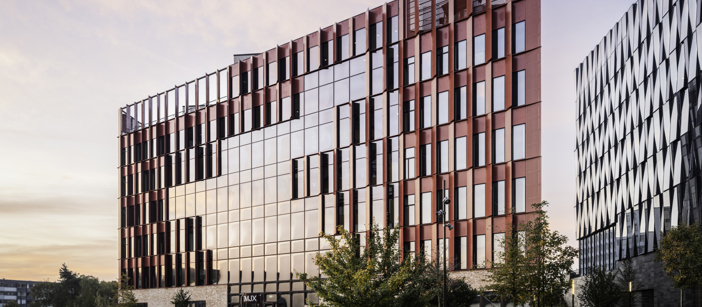 The red Speira aluminum façade of the Danish School of Media and Journalism.