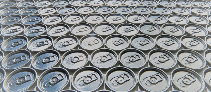 The top of aluminium cans, geometrically aligned next to each other.