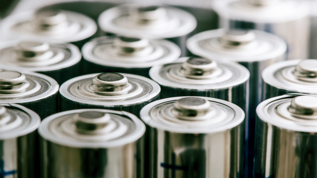 Aluminium components of batteries being stacked in a row.