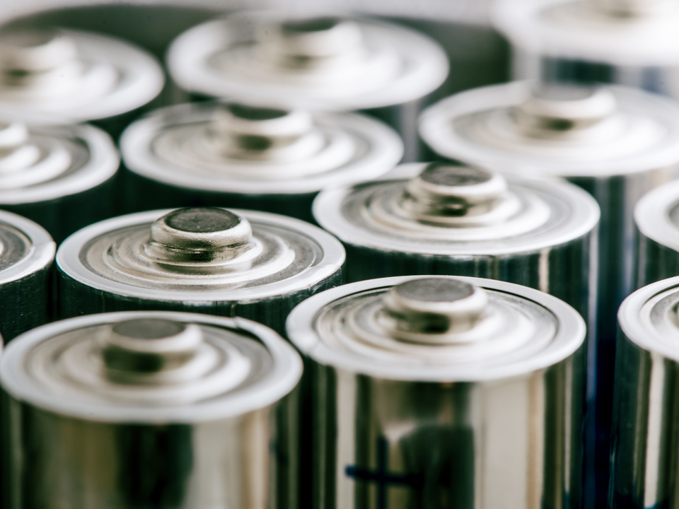 Aluminium components of batteries being stacked in a row.