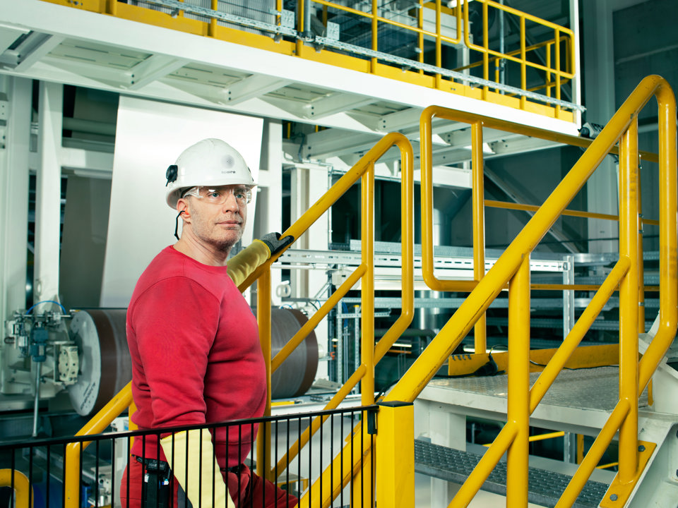 Speira employees at a yellow banister during production.