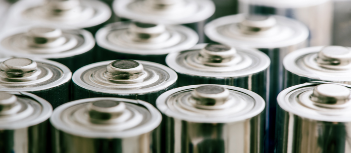 Aluminium components of batteries being stacked in a row.