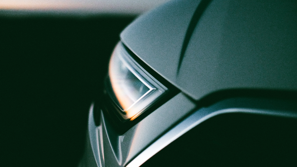 A car’s headlights reflecting the sunset.