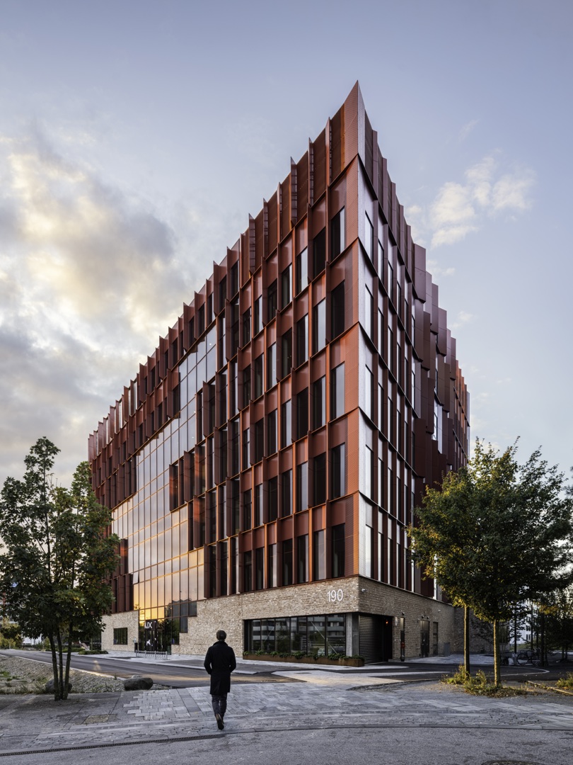 The red Speira aluminum façade of the Danish School of Media and Journalism.